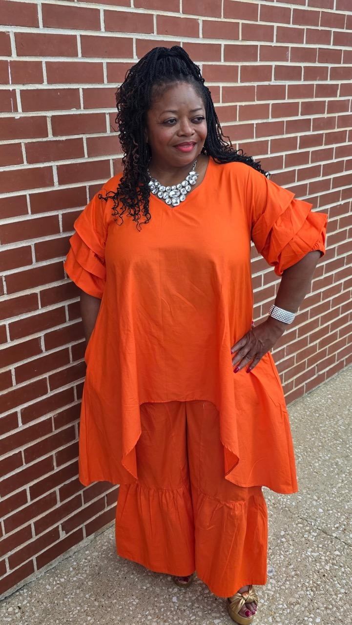 Beautiful Orange 2pc pantsuit it comes in many colors and we do have it in stock