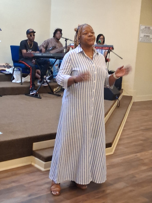 Annette Higdon the owner of Fresh Start Variety Shop is wearing a beautiful blue striped long maxi dress
